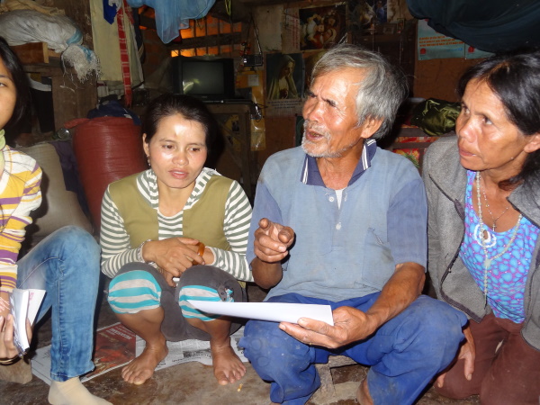 Sedang man talking to visitors about his past village